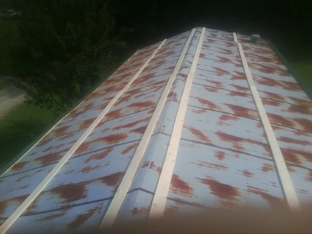 Rusted metal roof panels with new wood purlins before replacement — Storm Damage Roof Repair in The Villages by Roofing Brothers